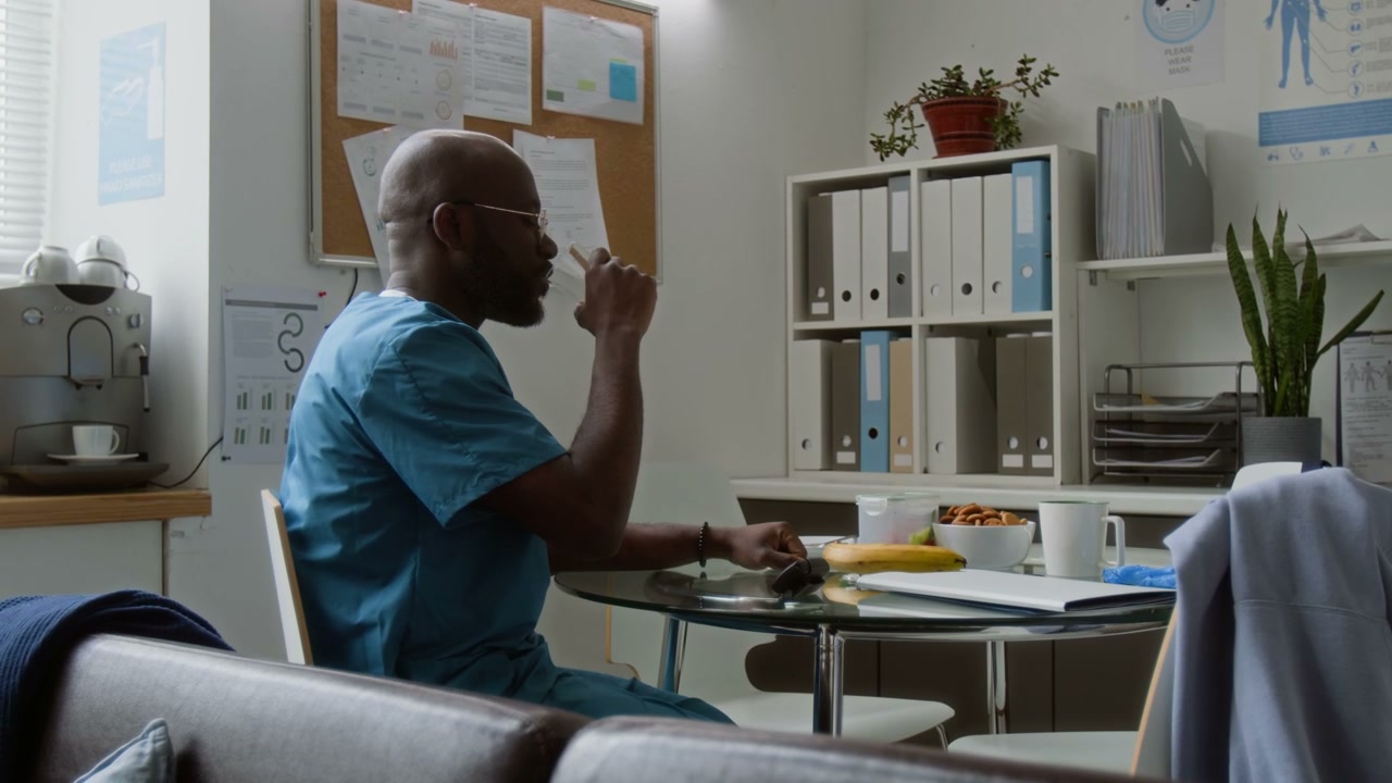 Doctor Takes Pill for Headache in Break Room