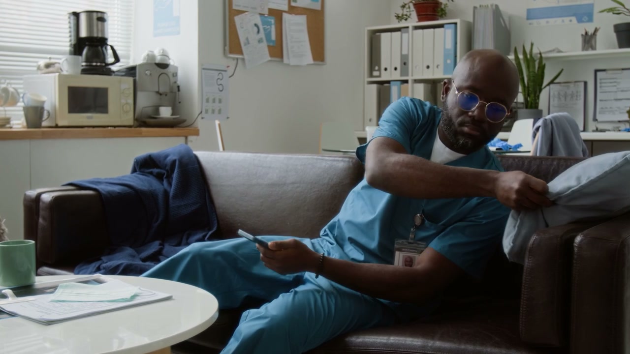 Healthcare Worker Relaxing with Phone in Break Room