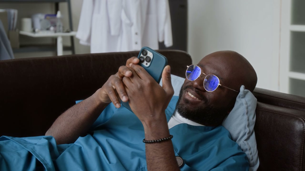 Doctor on Sofa Using Smartphone