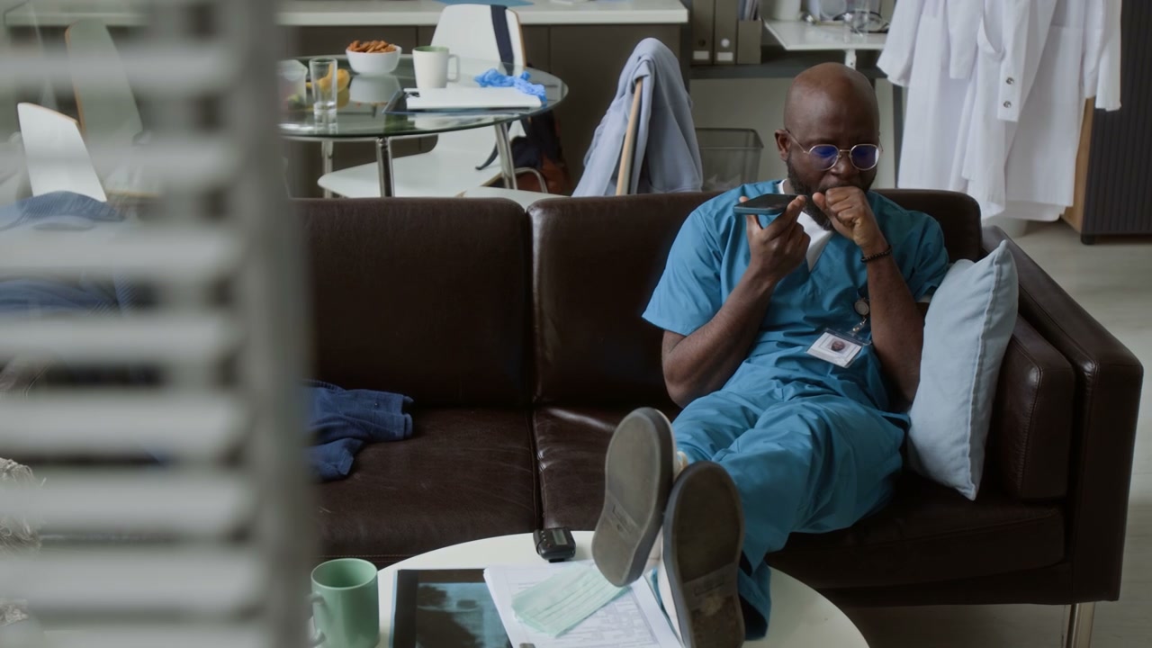 Doctor Relaxing and Talking on Speakerphone