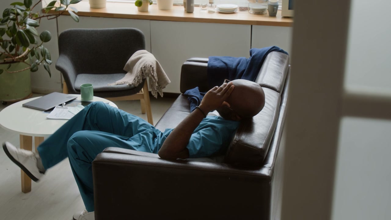 Doctor Resting on Sofa in Break Room