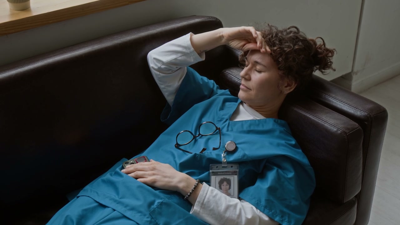 Tired Doctor Resting on Sofa
