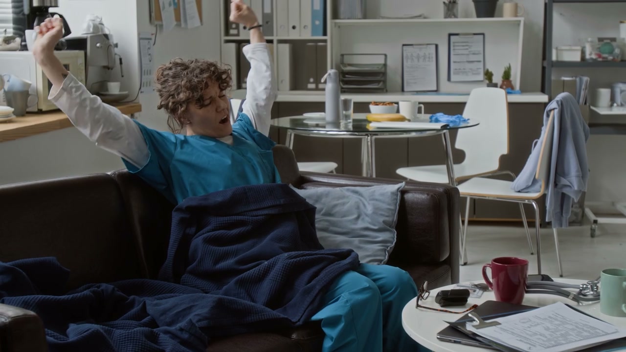 Clinician Waking Up and Stretching in Break Room