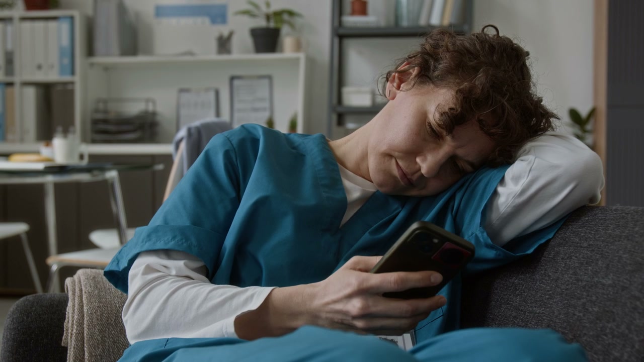 Doctor Resting and Scrolling on Smartphone