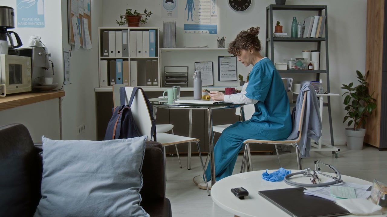Female Doctor Using Smartphone on Break