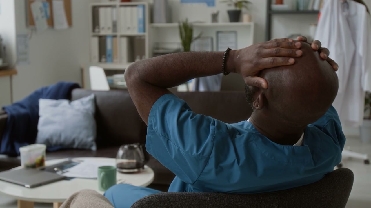 Male Doctor Relaxing in Hospital Break Room