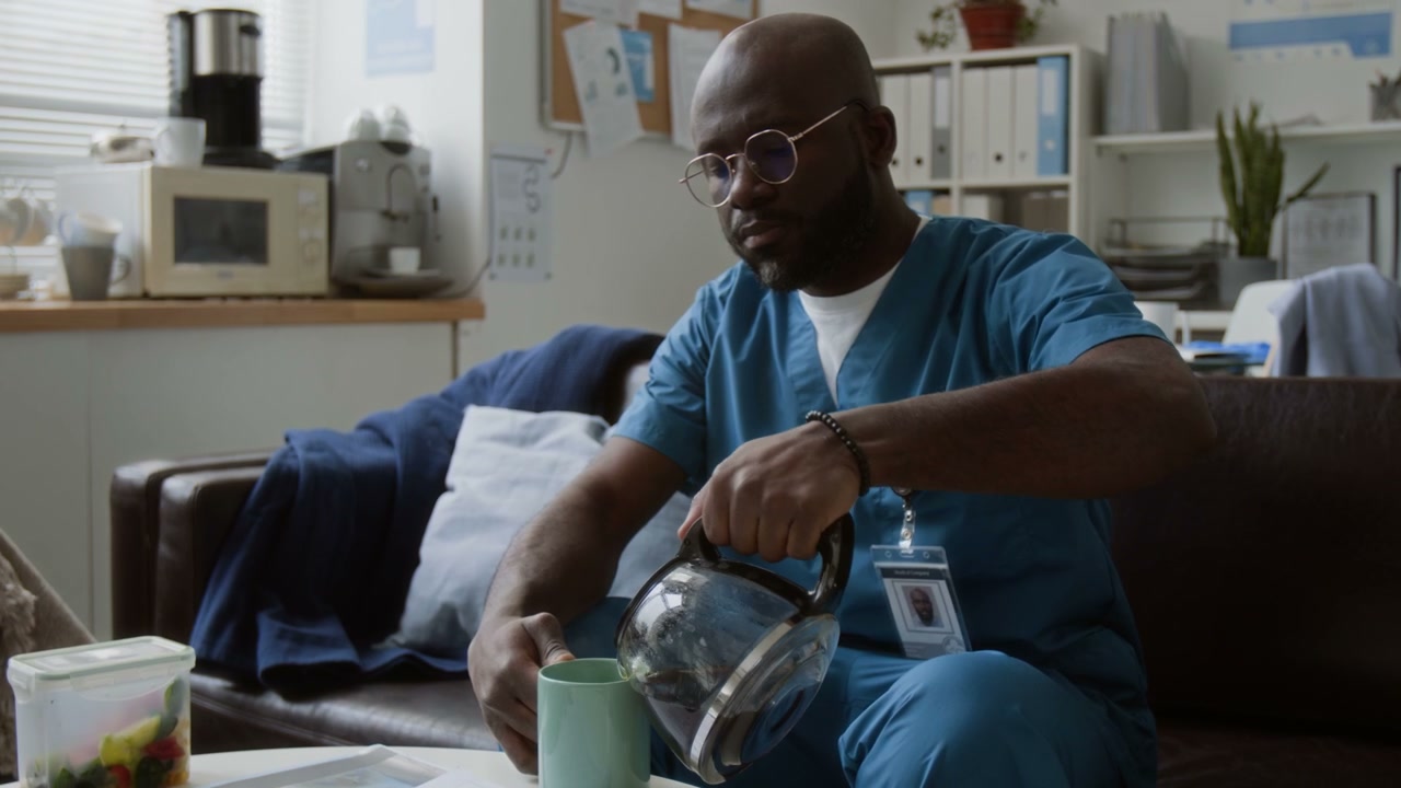 Doctor Pouring Coffee in Break Room