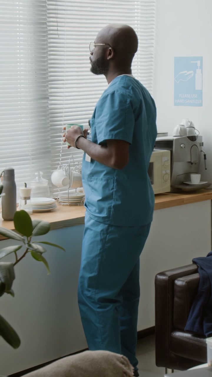 Man Doctor Taking Break in Staff Room