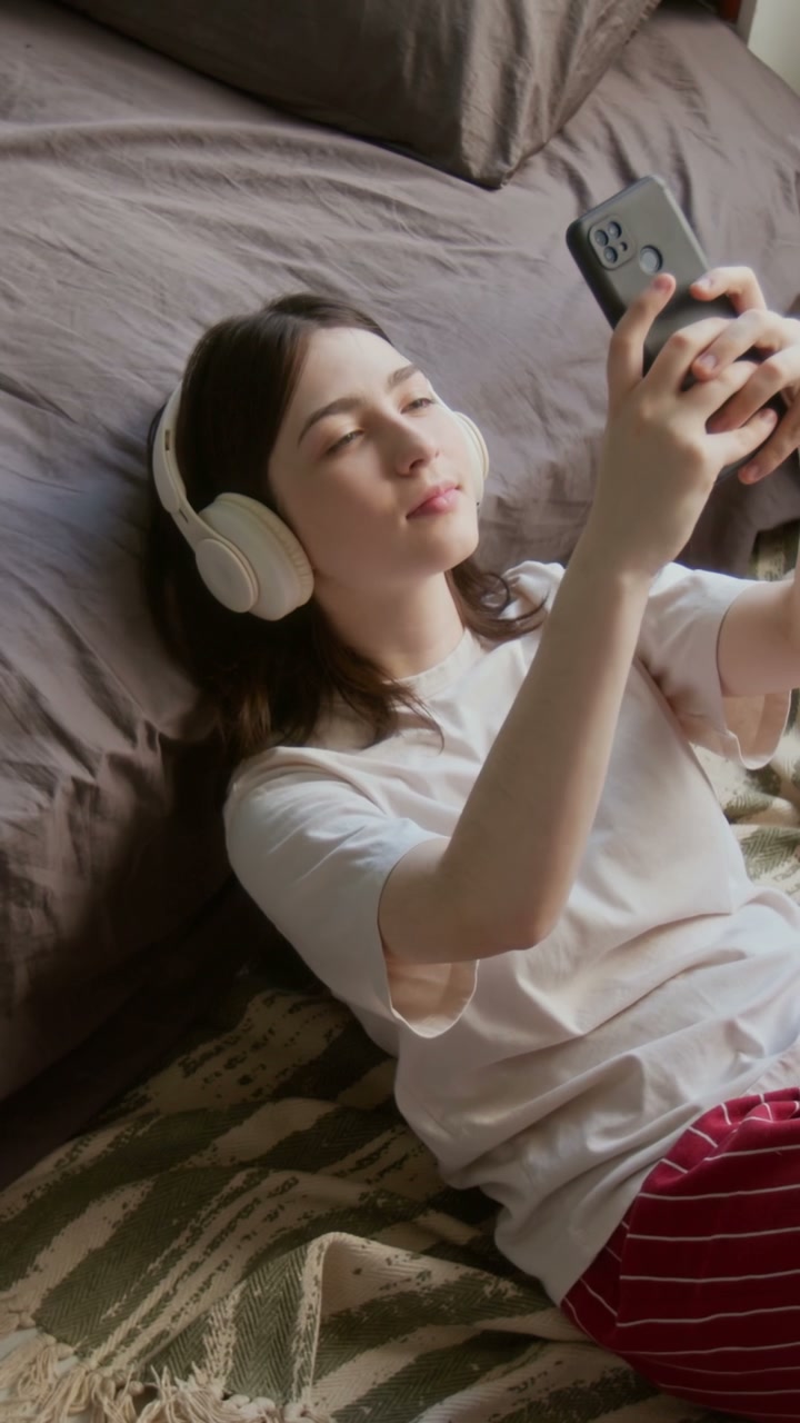 Young Woman Relaxes Listening to Music with Headphones