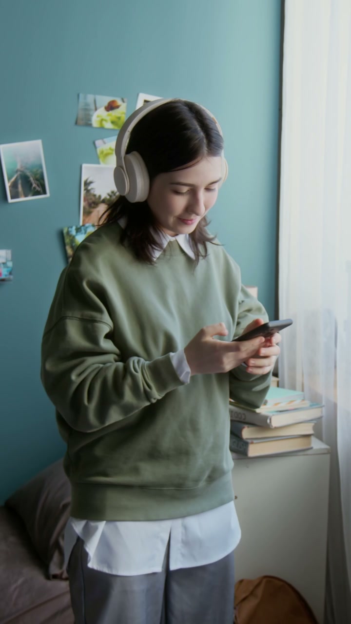 Young Woman Puts on Headphones and Dances