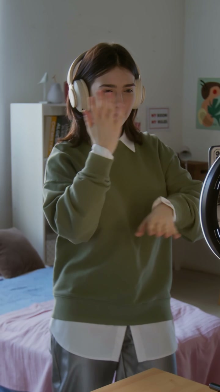 Teenage Girl Dancing to Music in Bedroom