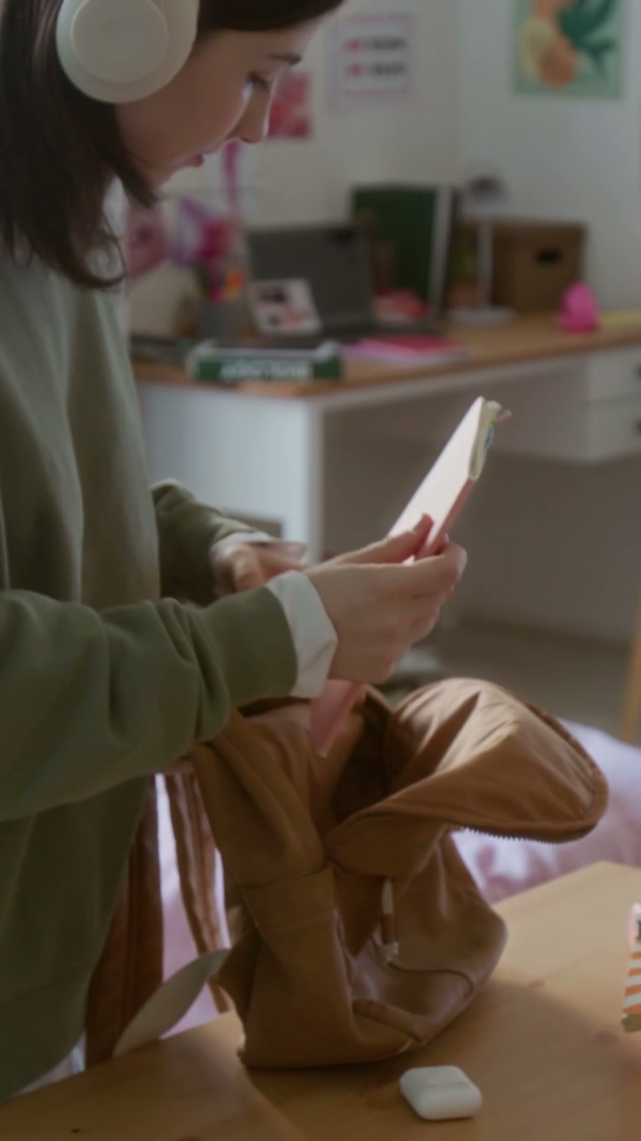 Teen Girl Packing Backpack at Desk