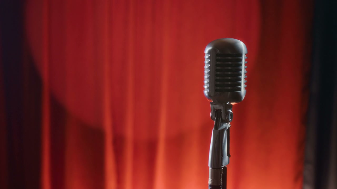 Vintage Microphone on Stage with Red Curtains