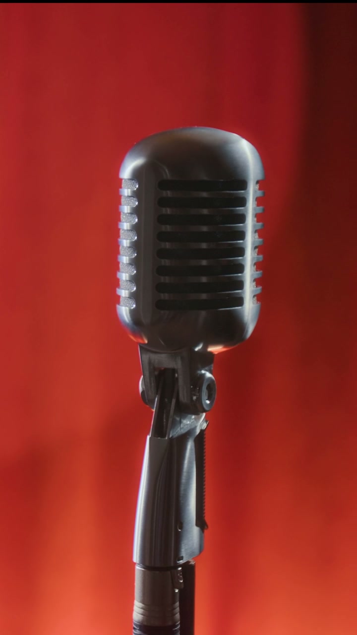 Vintage Microphone Against Red Curtain