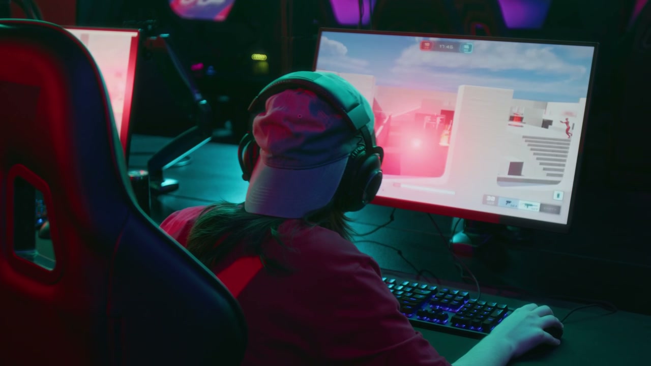 Unrecognizable Young Gamer Manipulating Red Cyborg Avatar in Shooter Game