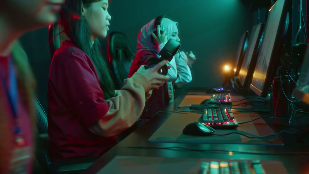 Multiethnic Female Gamer Team Sitting Down in front of Computers for Tournament