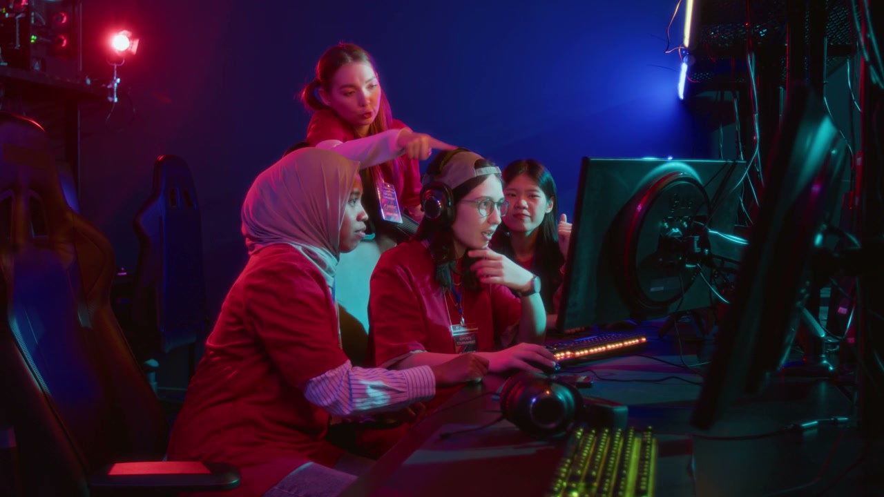 Team of Young Female Gamers Exploring New Map in Multiplayer Online Game