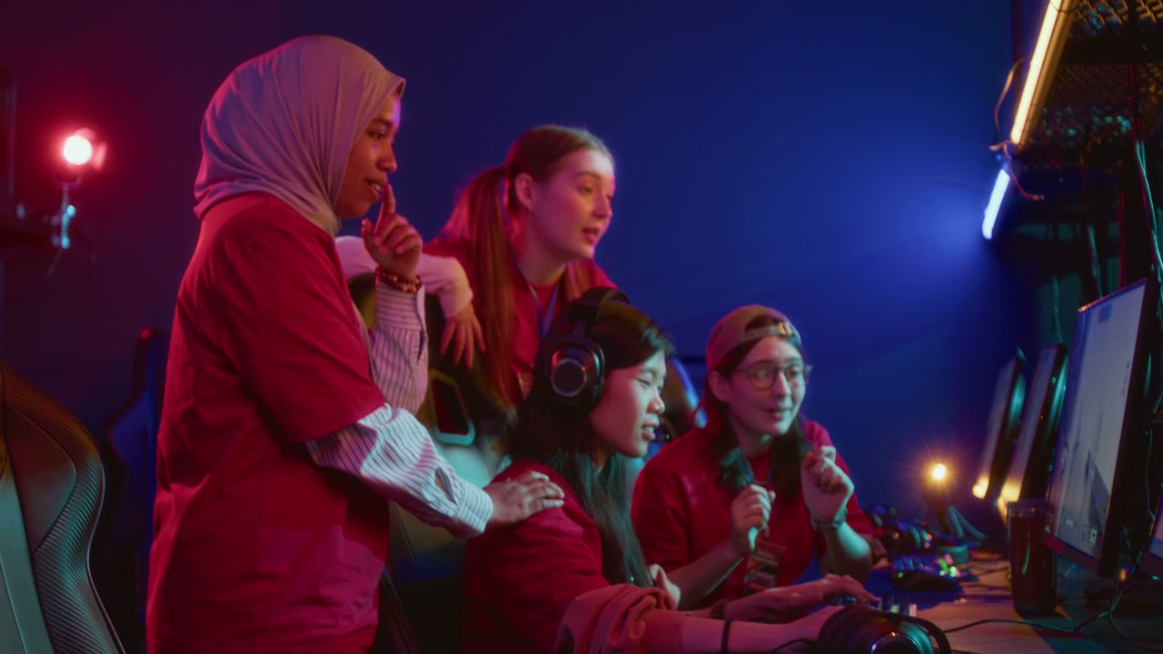 Female Cybersport Teammates Supporting Friend Playing Shooter Match