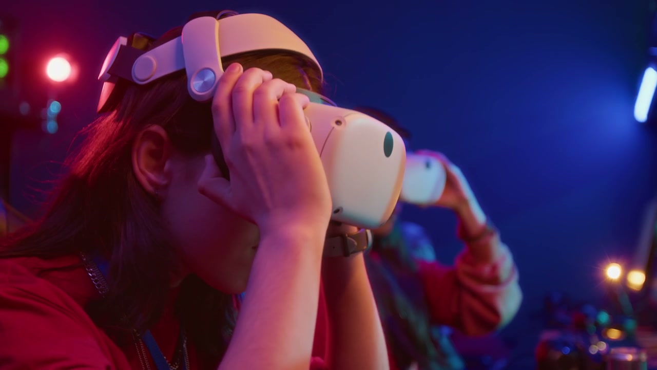 Two Diverse Girls Putting on VR Headsets to Play Online Videogame