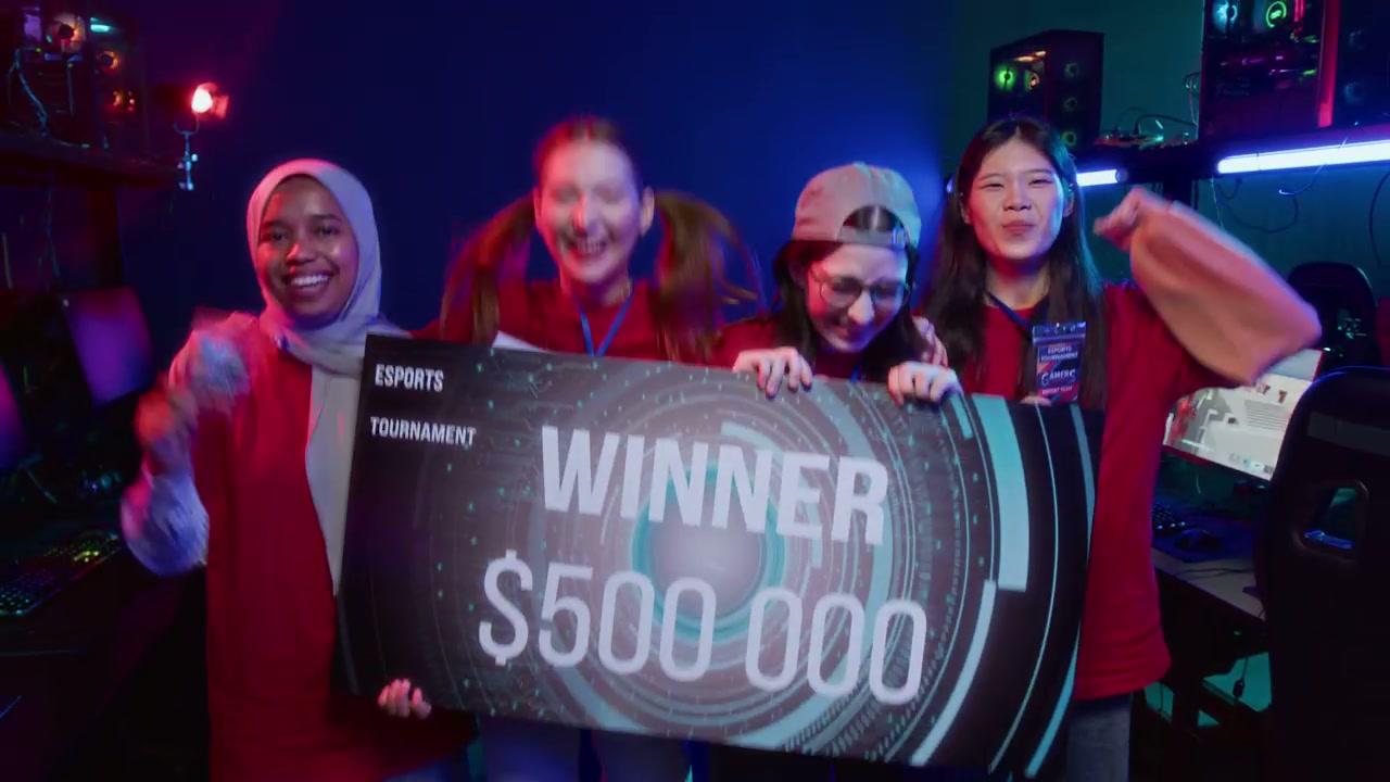 Team of Thrilled Multiethnic Female Gamers Posing for Photos with Prize Check