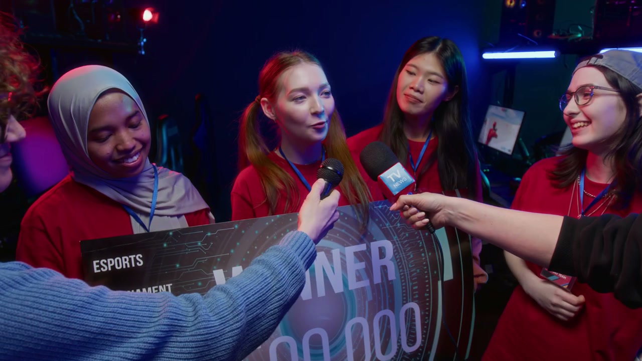 Excited Female Gamer Giving Interview while Posing with Winning Team