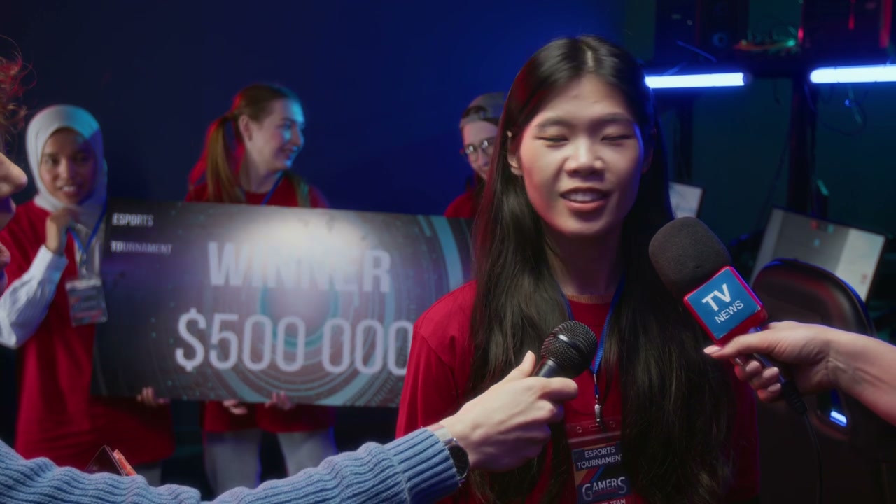 Asian Girl Giving Interview after Winning Cybersport Tournament with Team
