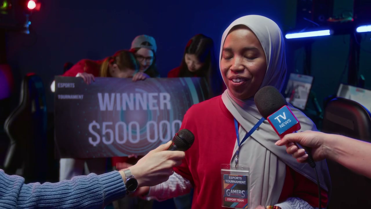 Cheerful Muslim Female Gamer Speaking to Journalists after Winning Tournament