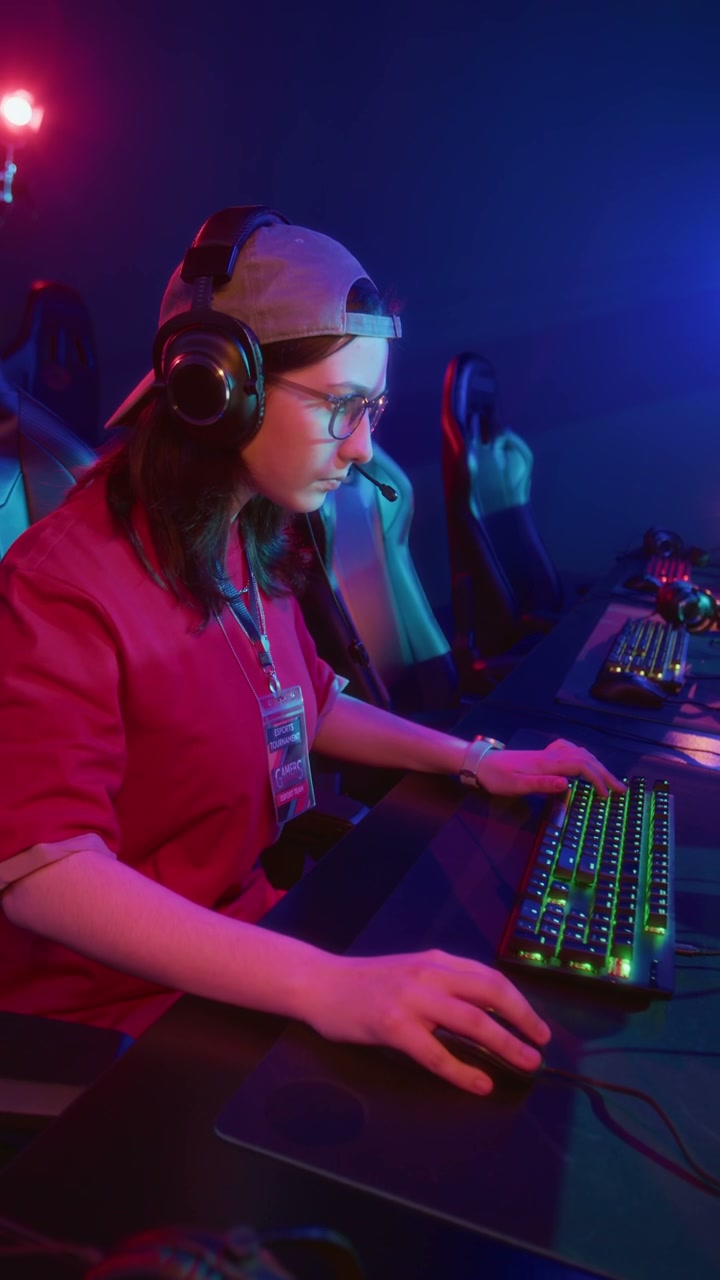 Geeky Teenage Caucasian Girl Playing Online Video Game in Cyberclub