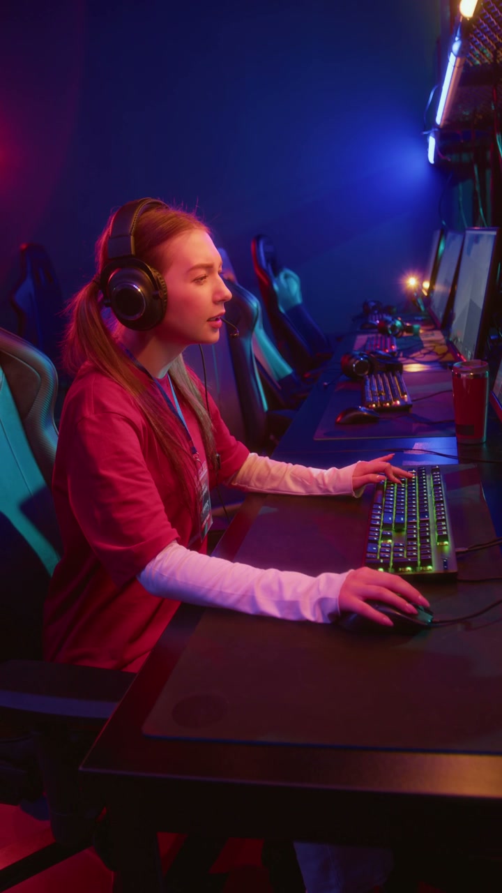 Excited Young Caucasian Girl Participating in Online Tournament in Cyberclub
