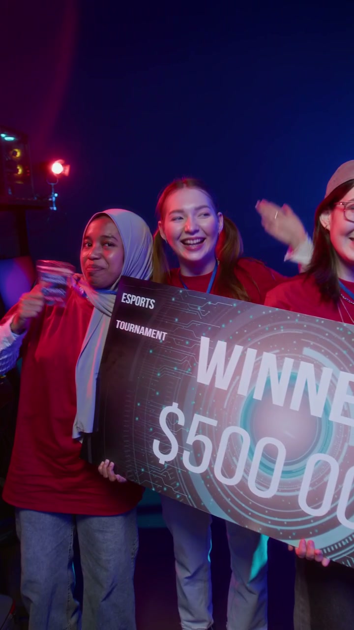 Happy Diverse Female Cybersport Team Posing for Photos with Trophy Check