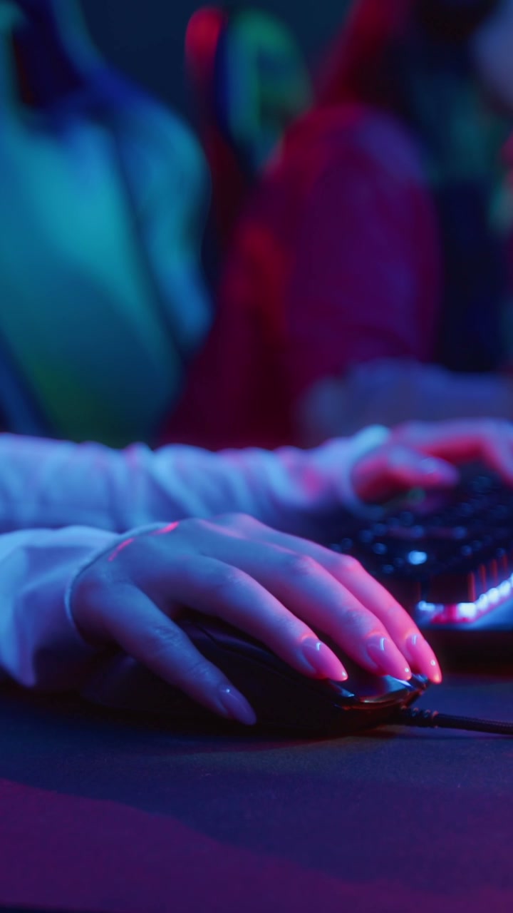 Female Gamer Playing with Neon Keyboard and Mouse