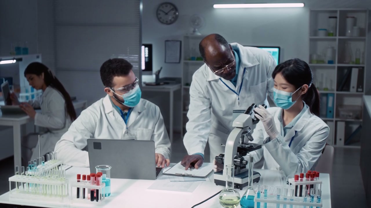 Scientists Working with Microscope in Lab