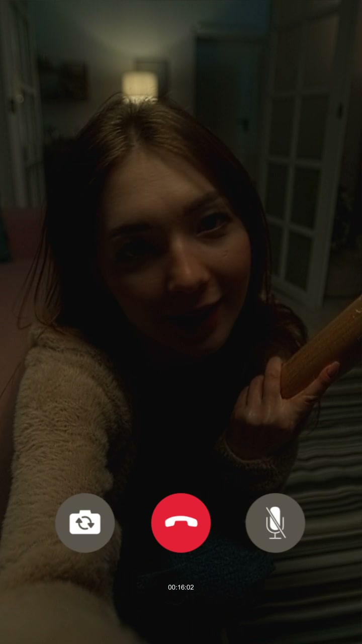 Scared Woman on Video Call Holding Bat