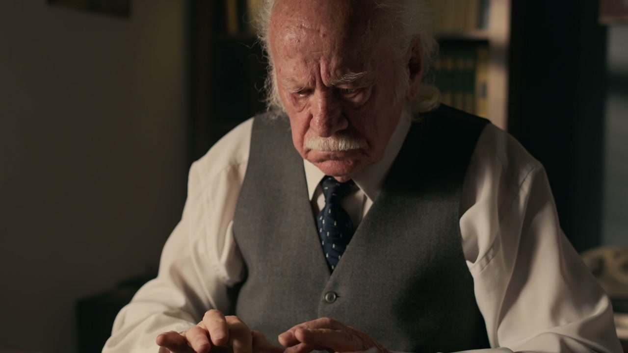 Elderly Author Focused on Typewriter