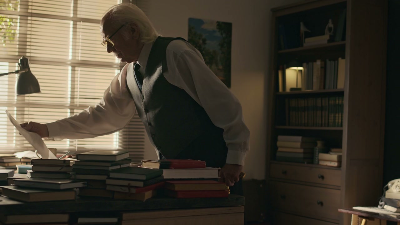 Elderly Writer Reading Document in Study