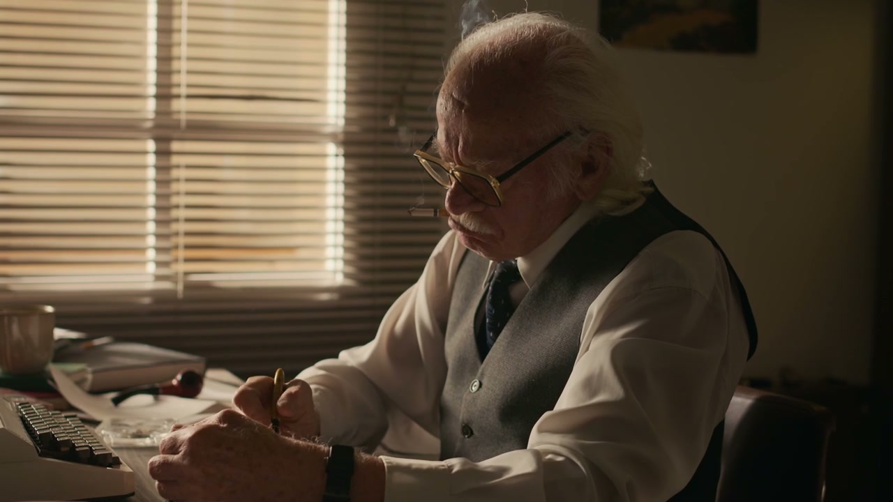 Senior Writer Smoking at Office Desk