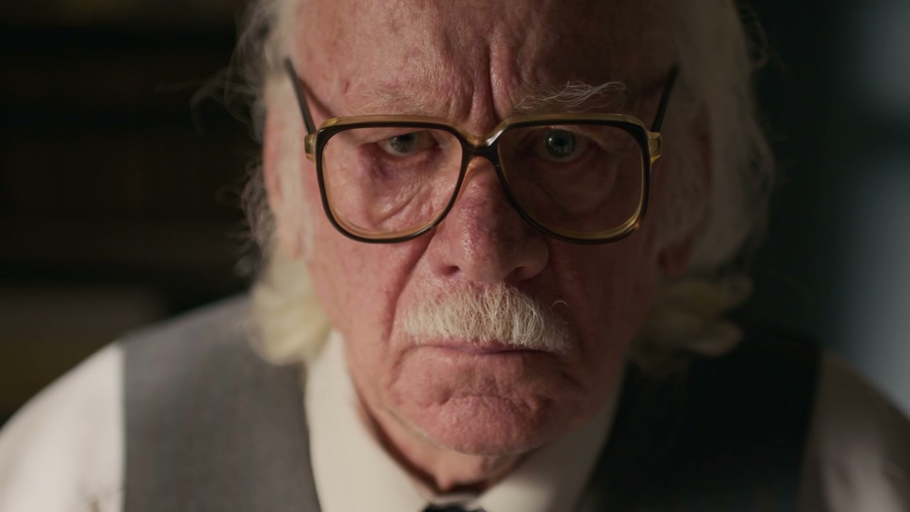 Close-Up of Focused Senior Writer in Glasses