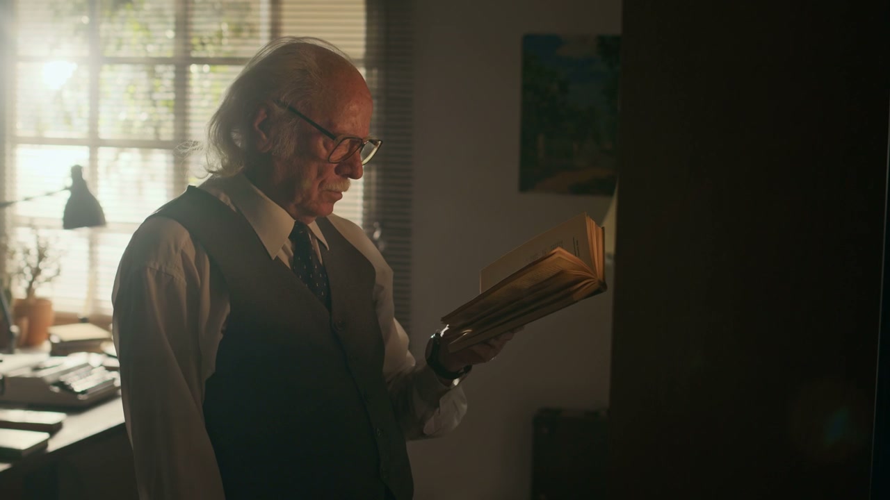 Elderly Writer Reading Book in a Vintage Study