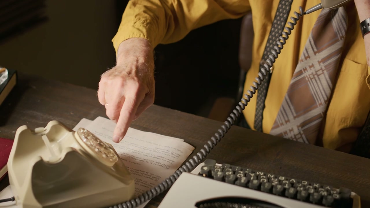 Elderly Man Dials and Talks on Rotary Phone