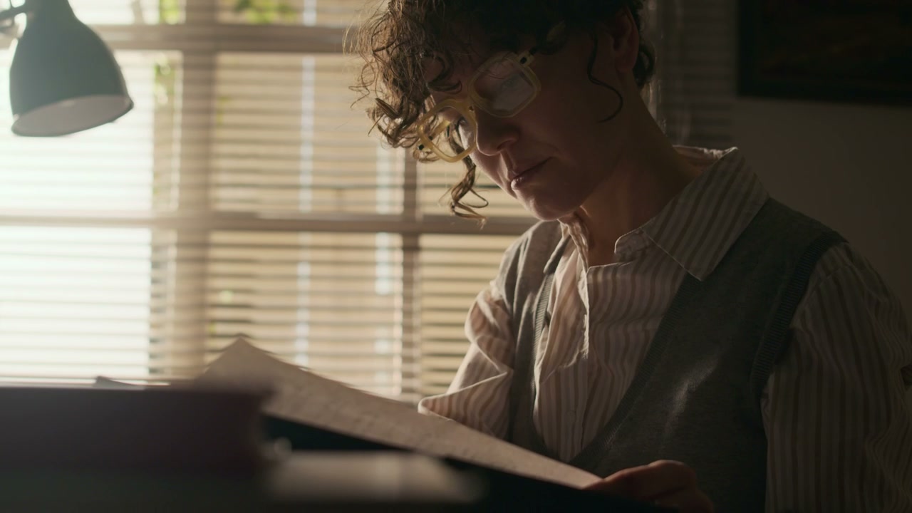 Writer Reading Manuscript at Desk