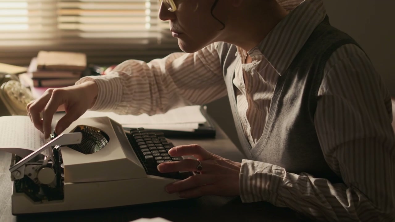 Woman Writer Typing on Vintage Typewriter