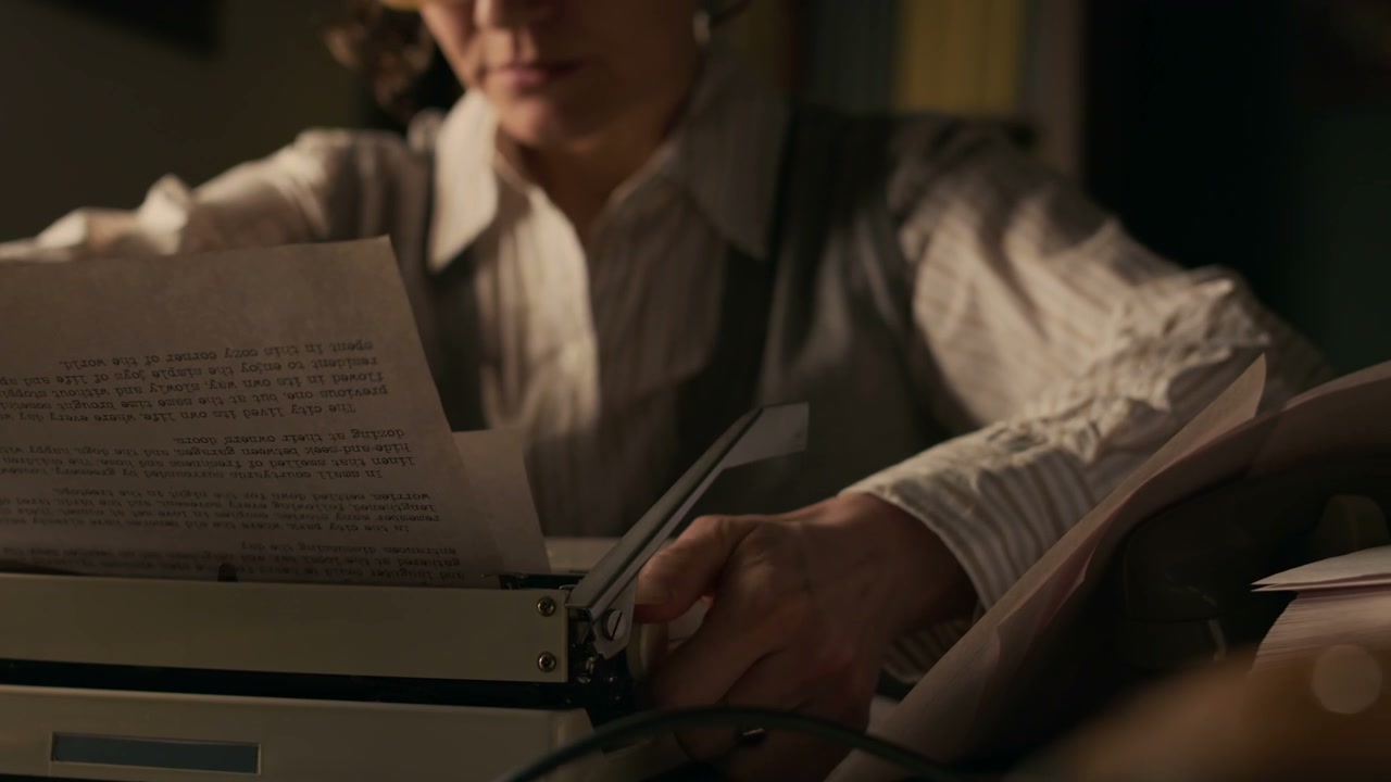 Writer Reviewing Document on Typewriter