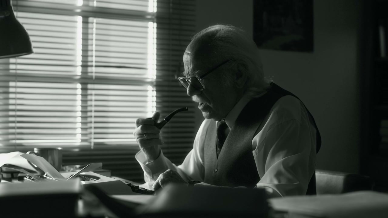 Senior Writer Smoking Pipe and Typing
