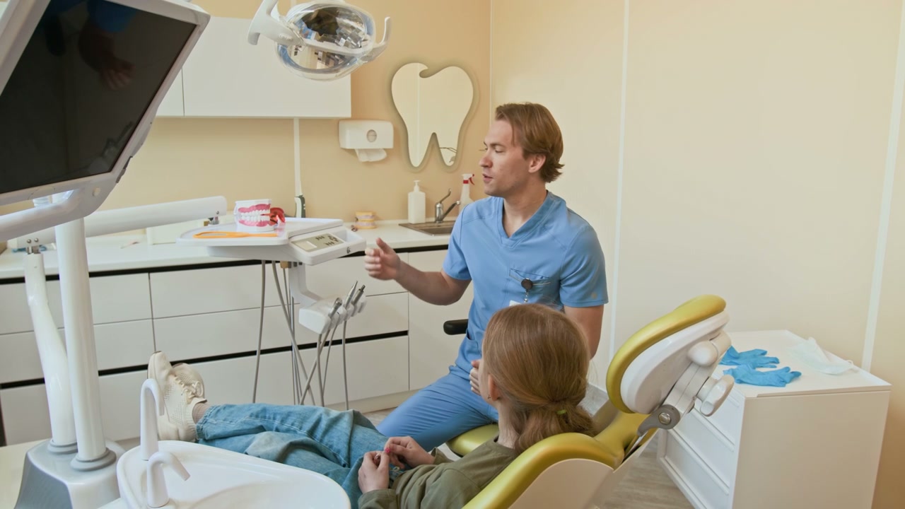 Dentist Explaining Dental Model to Child