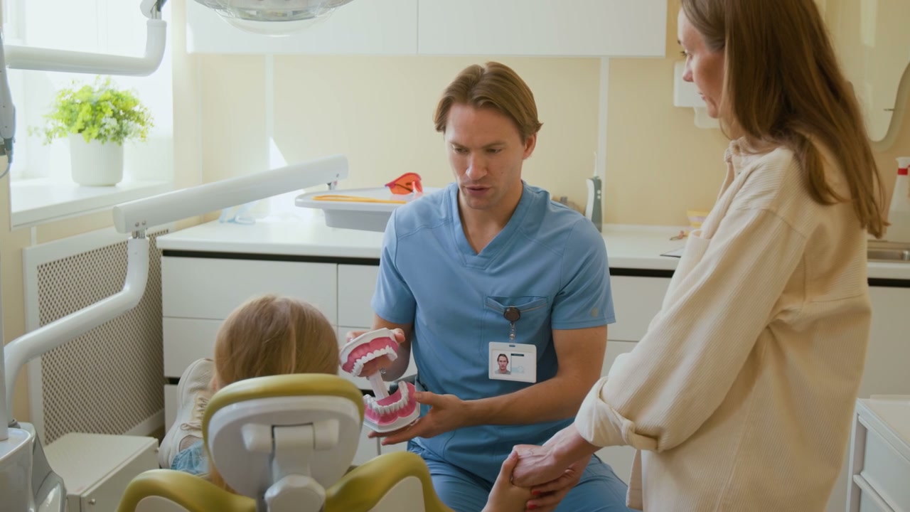 Pediatric Dentist Explaining Dental Health