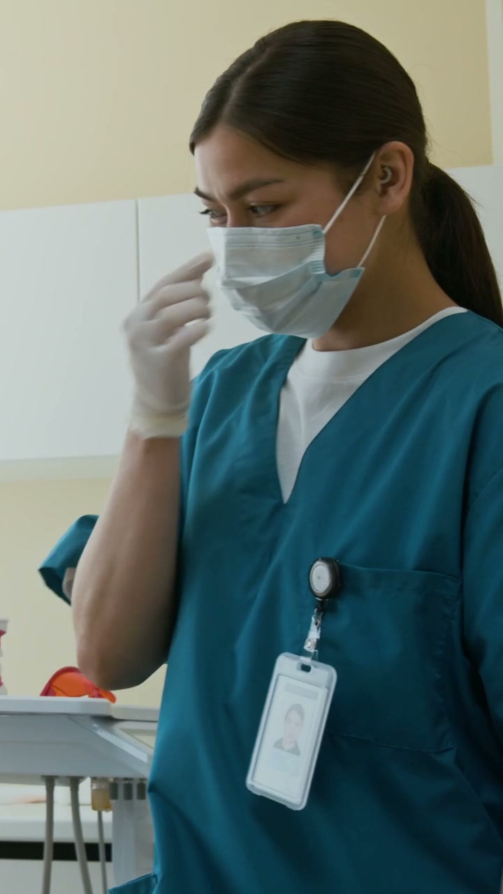 Dental Hygienist Adjusts Light in Clinic