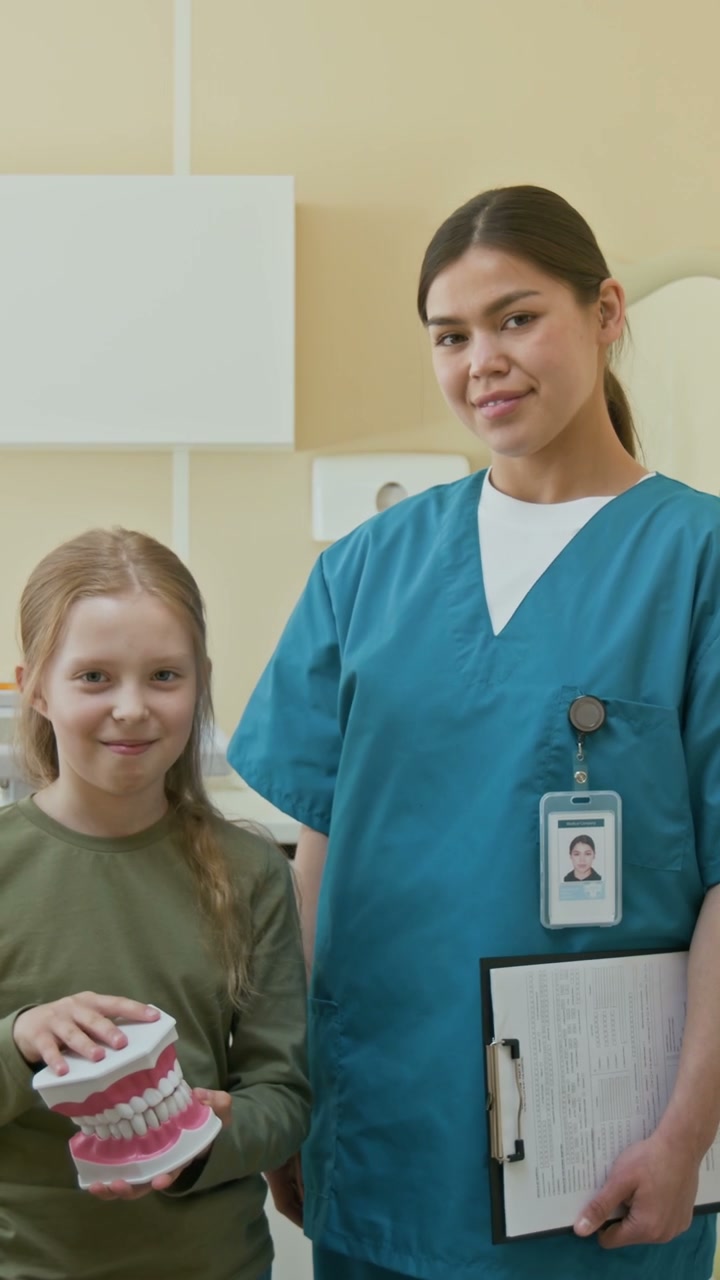 Pediatric Dentist and Girl Patient Smiling