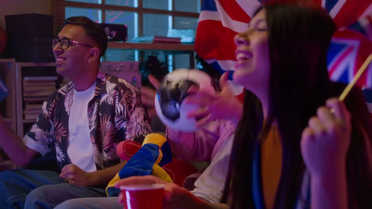 Friends Cheering While Watching Football Match