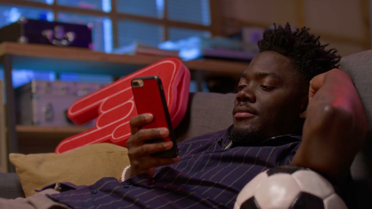 Sports Fan Watching Game on Smartphone