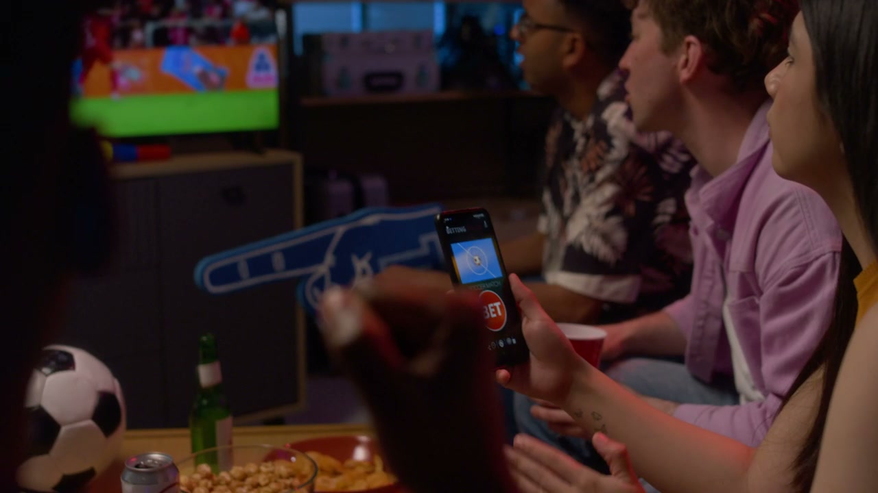 Friends Watching Soccer and Online Betting